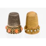 A Victorian two tone gold thimble set with pearls to base,