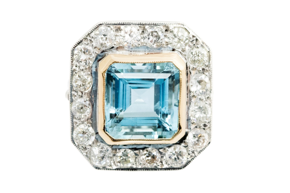 A large aquamarine and diamond octagonal cluster white gold ring,