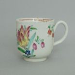 A Christians Liverpool polychrome coffee cup, decorated with a tulip & other floral sprigs,