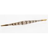 An Art Deco design diamond eleven stone bar brooch, 14ct gold with platinum setting,