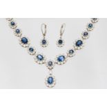 A sapphire and diamond multi cluster white gold necklace with matching earrings,