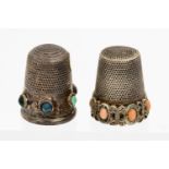 A Victorian silver thimble inset with six oval coral cabochon stones together with another