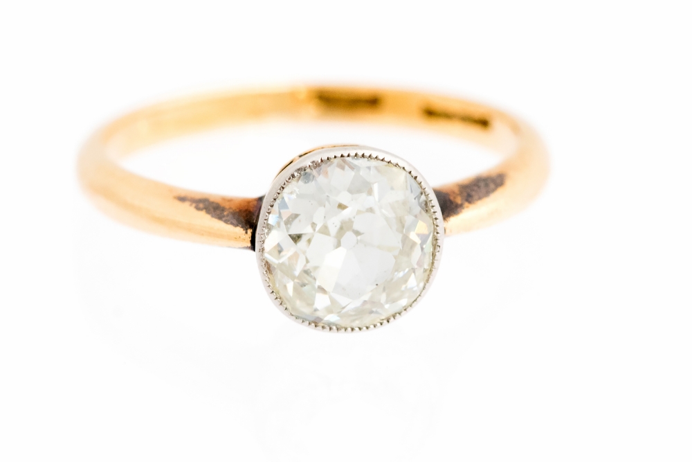 A diamond solitaire yellow gold ring,