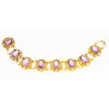 A Victorian amethyst and yellow gold bracelet comprising eight oval pierced links,