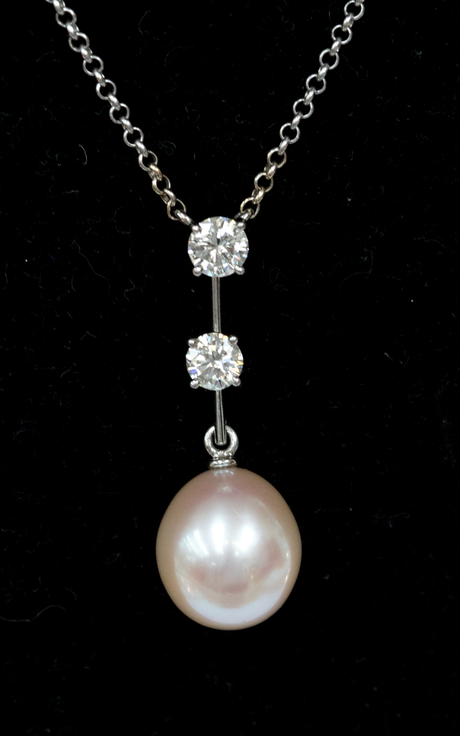 A pearl and diamond pendant, the pearl measuring approximately 14 x 12 mm,