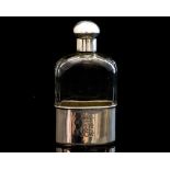 A Victorian glass flask bottle, the body facet cut with detachable silver cup and gilt interior,