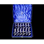 A cased set of twelve Victorian silver individual serving tongs, each with shell decoration,