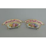 A small pair of Derby letter racks, highly decorated with floral sprays and a Rose border rim,