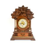 A late Victorian oak cased bracket clock, manufactured by the British United Clock Company,