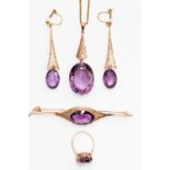 An Edwardian boxed suite of amethyst and yellow metal jewellery, comprising pendant,