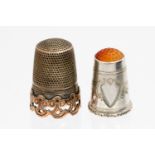 A Victorian silver and gold pierced thimble on undulating base,