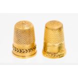 A Victorian gold thimble chased with fruiting vine to band before vacant cartouche together with