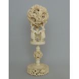 A large Chinese antique ivory puzzle ball on an elephant stand, circa 1900,