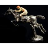 A novelty car mascot in the form of a horse and jockey, silvered and cold painted,