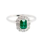 An emerald and diamond octagonal cluster white gold ring,