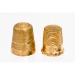 A 9ct gold thimble with matt textured ground, together with another Victorian gold thimble,