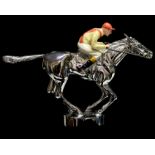 A set of three chromium plated novelty car mascots in the form of horse and jockeys,