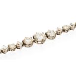 A diamond line bracelet set with fourteen alternating French square cut and twelve round brilliant