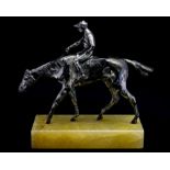 A silvered metal desk model of a jockey on a trotting horse, circa 1930's, height 19cm ,