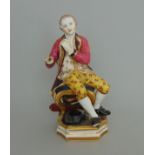 A Derby figure of a seated musician dressed in bright attire, circa 1815,