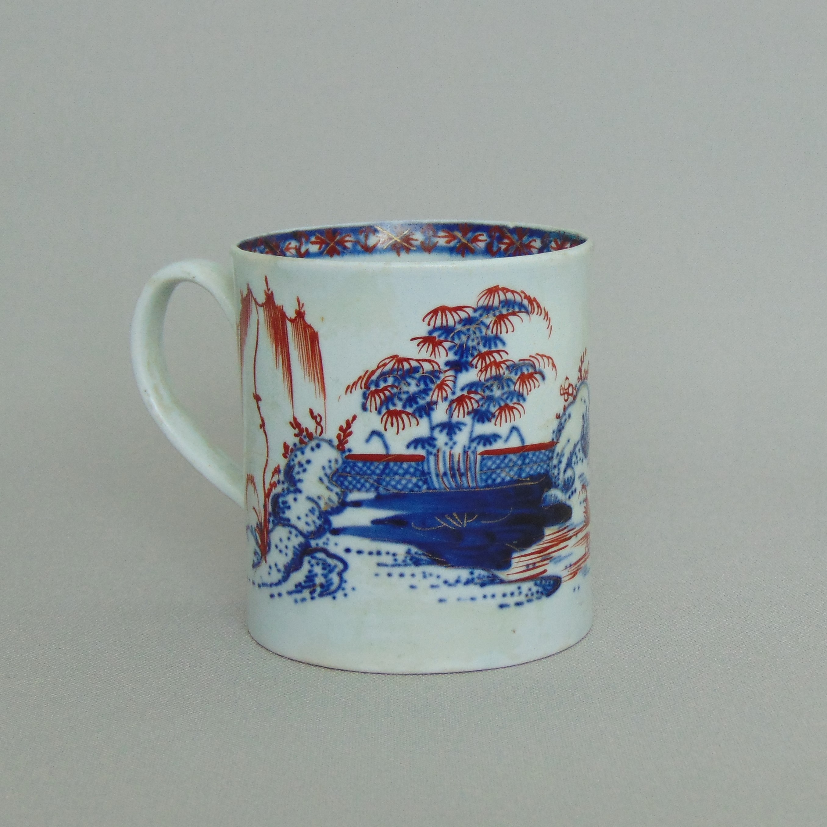 A Chaffers Liverpool coffee can, decorated with an underglaze landscape & overglazed red,