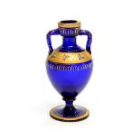 Moser, a Bohemian enamelled blue glass vase, twin handled Grecian pedestal form,