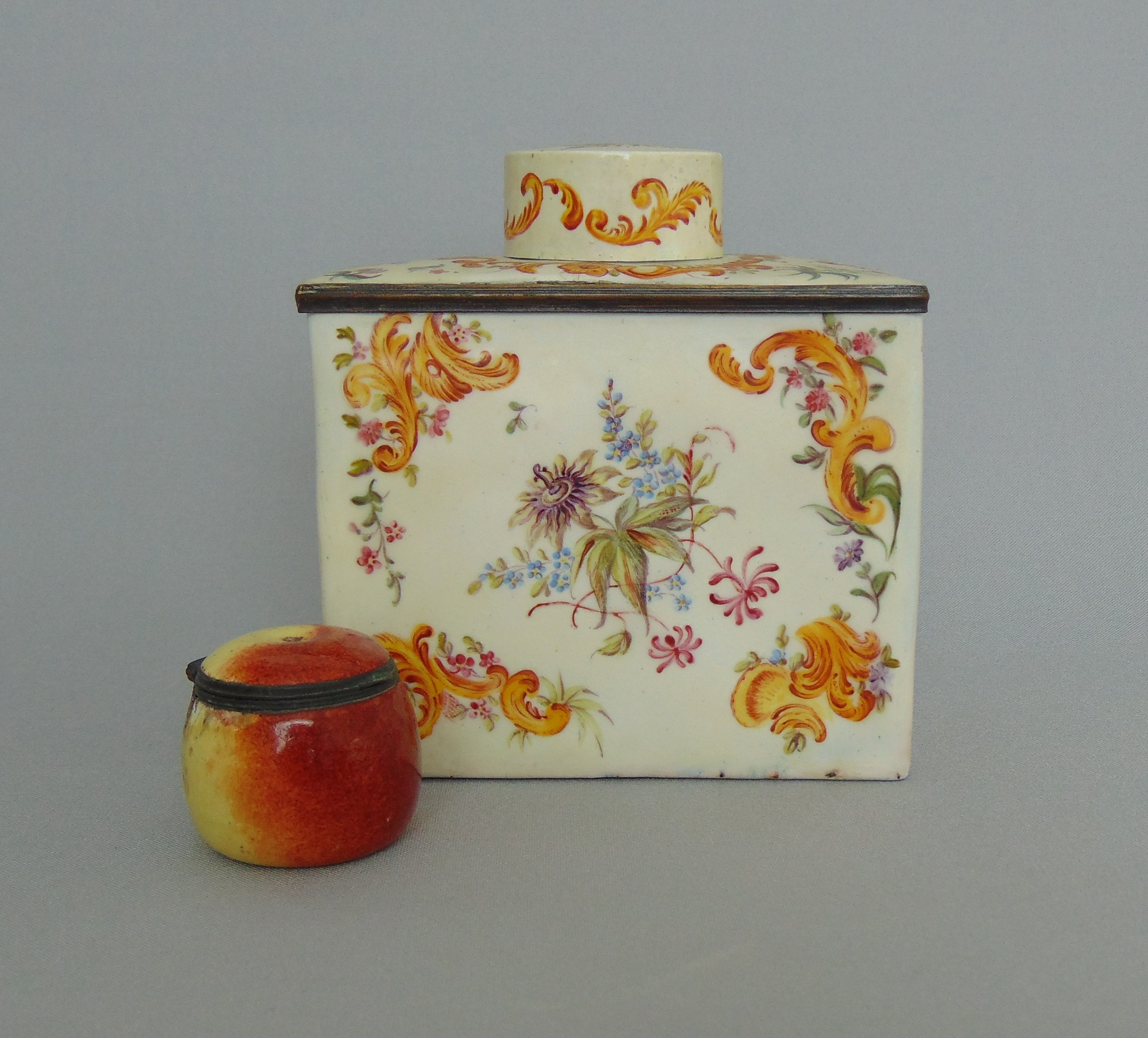 A South Staffordshire enamel fruit shaped bonboniere and an English enamel rectangular shaped tea