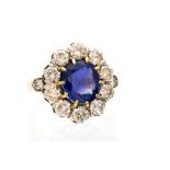 A Burmese sapphire and diamond cluster yellow metal ring,