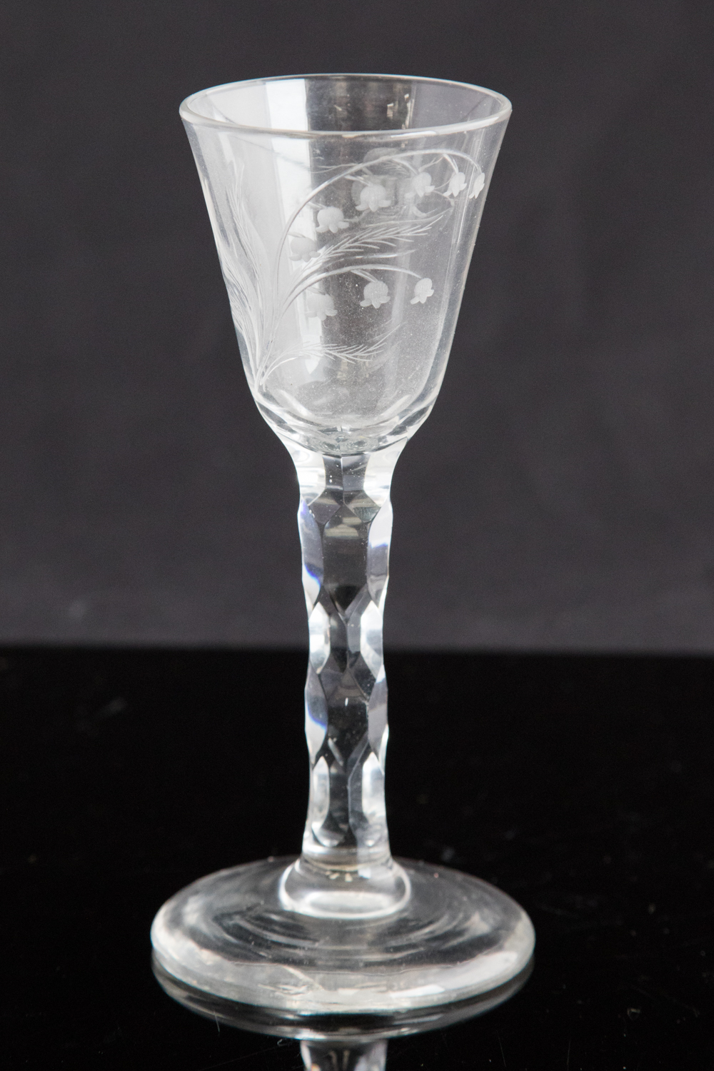 An 18th century wine glass, circa 1750, the round funnel bowl engraved with snowdrops and a bee,