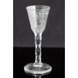 An 18th century wine glass, circa 1750, the round funnel bowl engraved with snowdrops and a bee,