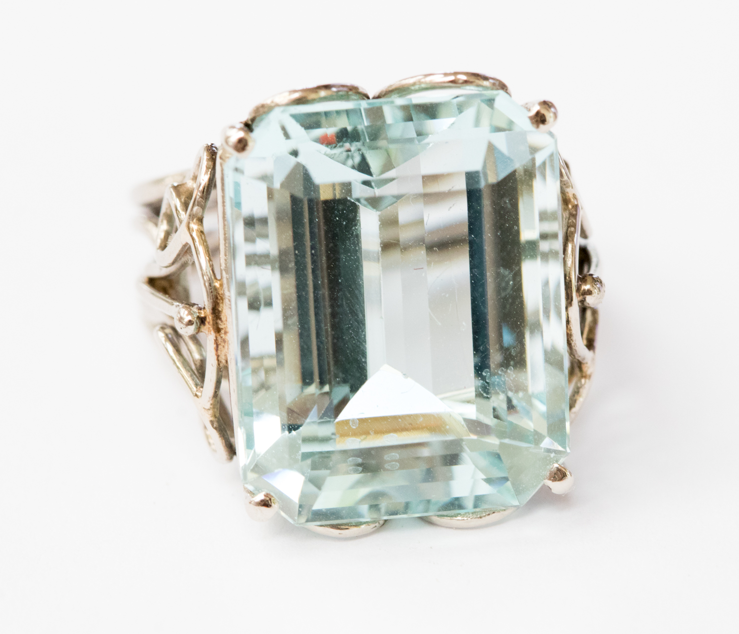 An aquamarine and white metal ring,