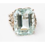 An aquamarine and white metal ring,