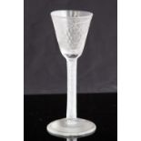 An 18th century wine glass, circa 1755, the round funnel bowl engraved with vine,