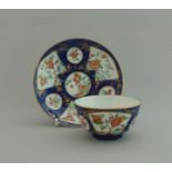 A Worcester tea bowl and saucer, blue powder ground,