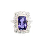 A tanzanite and diamond oblong cluster white gold ring,
