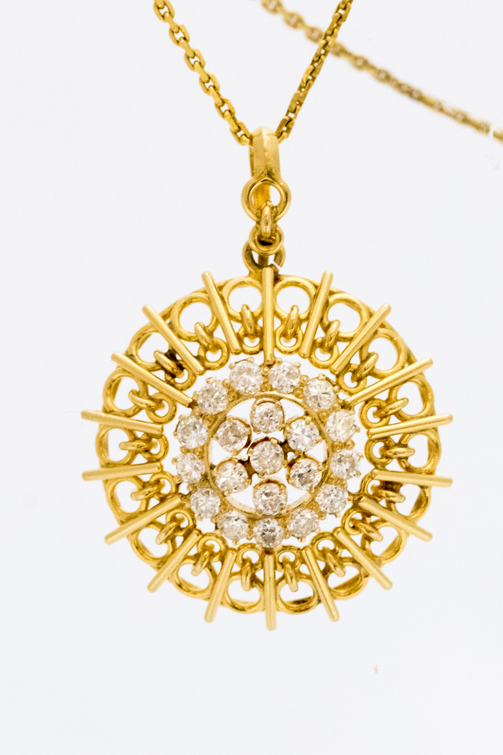 A diamond pendant of sunburst openwork design,