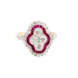 An Art Deco style diamond and ruby set shaped oval cluster yellow gold ring with diamond set