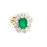 An emerald and diamond cluster ring, the centre emerald approx 1.