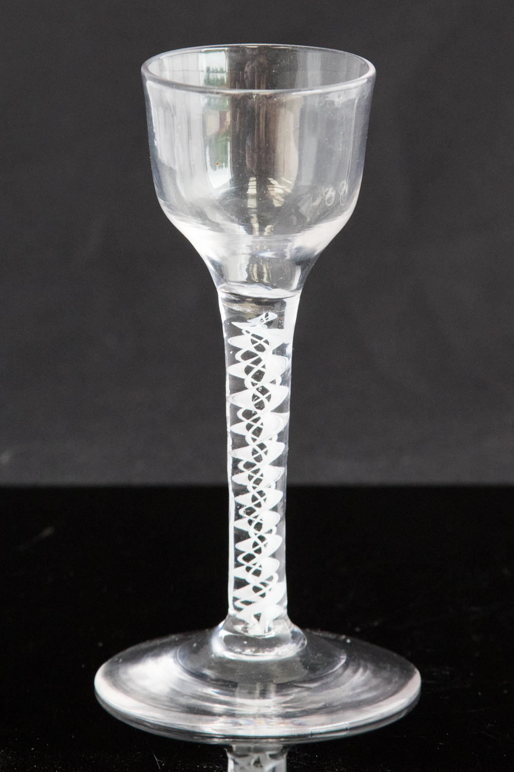 An 18th century wine glass, circa 1755, the plain ogee bowl supported on an opaque,