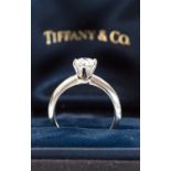 A Tiffany diamond solitaire and platinum ring, with AGI insurance certificate, 0.