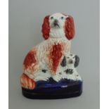 A Staffordshire group of two spaniels sitting on a cobalt blue glazed base, circa 1850,
