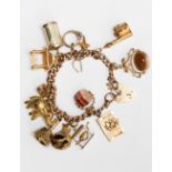 A 9ct gold charm bracelet, together with thirteen assorted charms and padlock clasp,