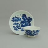 A Worcester blue and white tea bowl and saucer, decorated with 'Man in Pavilion' pattern,