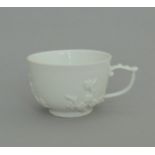 A Meissen small white tea cup, with applied sprigs and ornate handle, circa 1745, 4cm high,