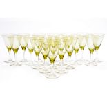 A suite of 19 Bohemian wine glasses, green tinted conical bowls on milled edge facet cut stems,