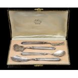 A twentieth century white metal, possibly French, cased preserve set, each with floral decoration,