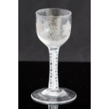 An 18th century wine glass, circa 1760, the ogee bowl engraved with wine and bird,