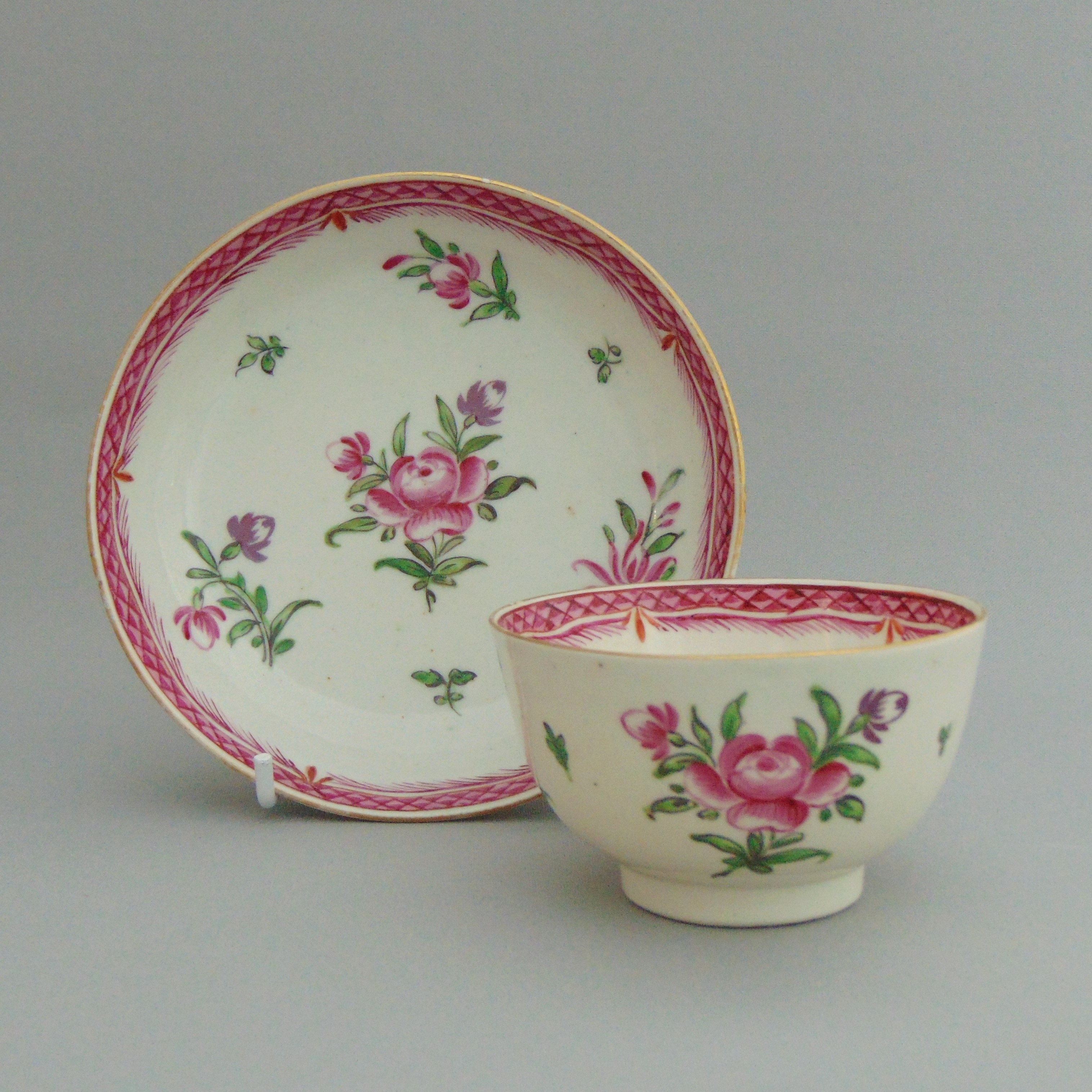 A Caughley polychrome tea bowl and saucer, pink border & flower sprigs, circa 1785,