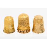 A Victorian gold thimble chased with a landscape band before indistinct initials,