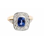 A sapphire and diamond cushion shaped cluster yellow gold ring with diamond set shoulders,